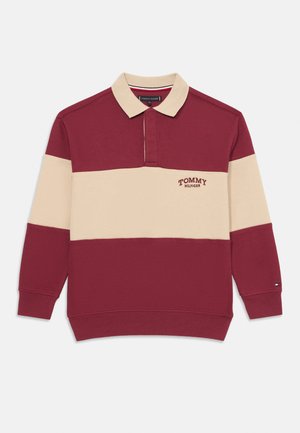 Langærmet polo i bordeaux og creme, med krave, frontlogo og ribbede manchetter. Fremstillet af textureret stof med kontrasterende farver.