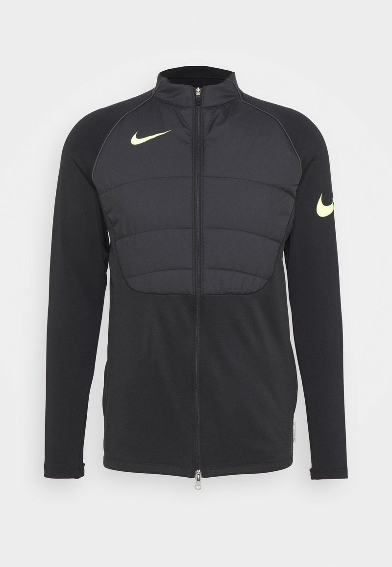 Veste de sport noire à zip intégral avec panneau avant matelassé et logos Nike Swoosh jaunes sur la poitrine et la manche gauche.