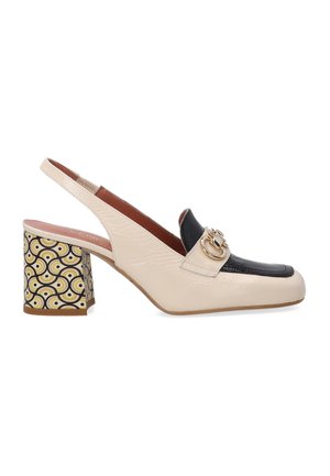 Beige and black slingback shoe with embossed texture, square toe, gold hardware, and patterned block heel in yellow and black circular design.