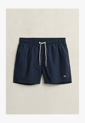 Donkerblauwe zwemshorts met elastische tailleband, witte trekkoord, zijzakken en een klein logo aan de linkerkant.