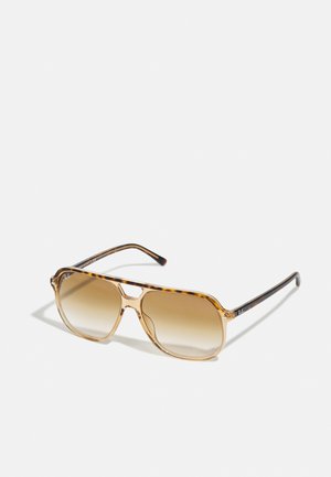 Sonnenbrille im Schildpatt-Design mit rechteckigem Rahmen, braunem Verlaufsglas und schlanken schwarzen Bügeln mit dezenten Logo-Akzenten.