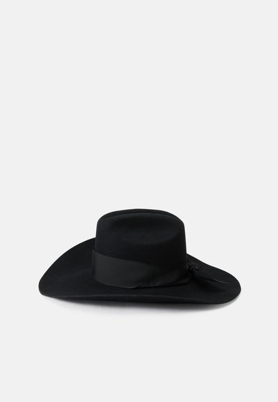 Cappello a falda larga in feltro nero con corona piatta e un nastro nero testurizzato attorno alla base, con una leggera curvatura lungo i bordi della falda.