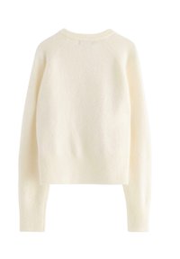 Cremefarvet, tekstureret sweater med rund hals, ribstrikkede manchetter og kant. Har et cropped design og raglanærmer for komfort.