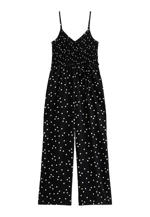 Tuta nera con pois bianchi, busto arricciato, spalline sottili e design a gamba larga. Presenta una cintura regolabile.