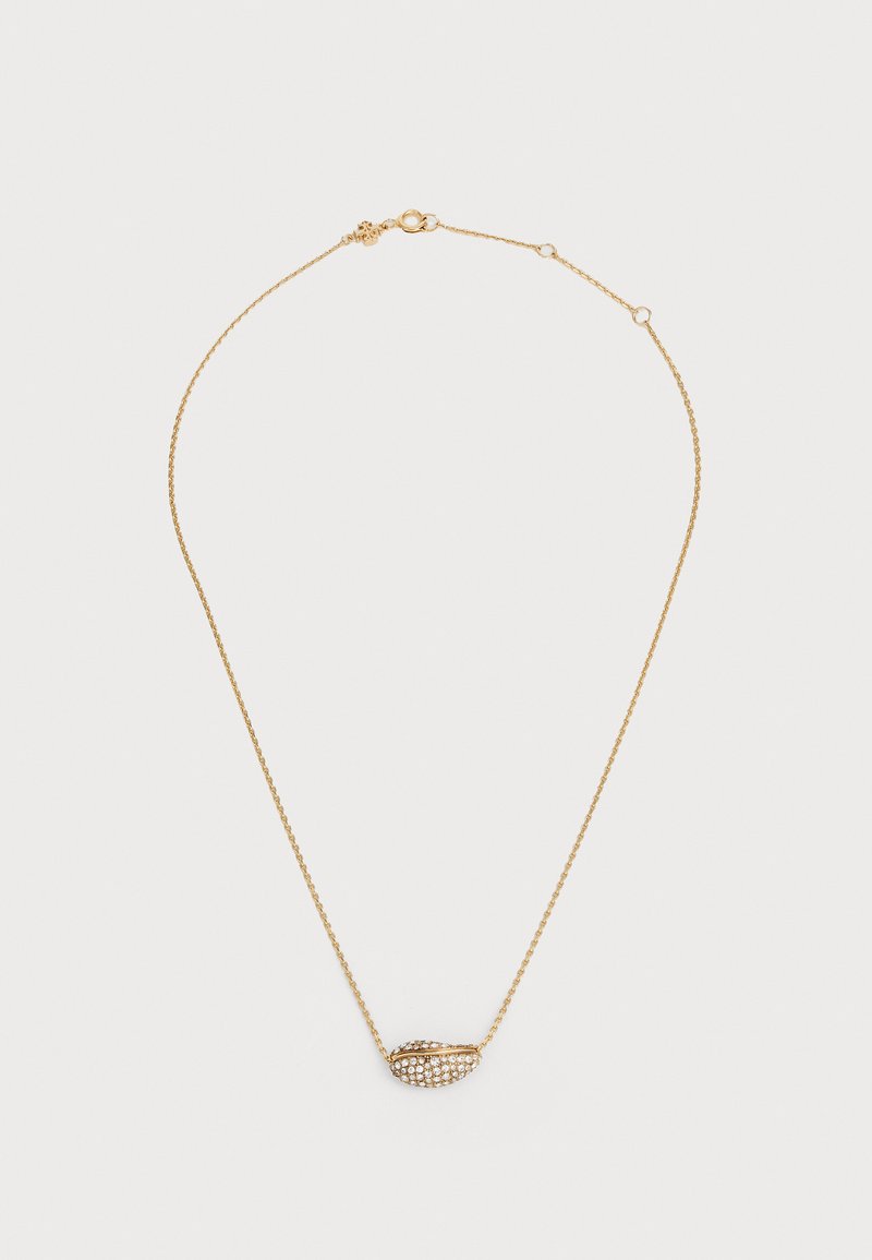 Zelts ķēdīte ar teksturētu, čaulu formas piekariņu, izrotātu ar caurspīdīgiem kristāliem. Satur aizdari un regulējamu garumu ķēdītēm.