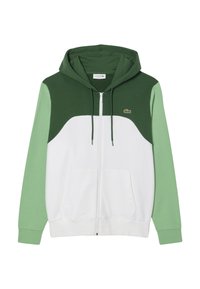 Zip-up hoodie met een witte basis en groene en donkergroene accenten, voorzien van een kangoeroezak en een Lacoste-logo op de borst.