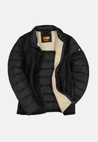 Mustat takki, jossa on tikattu muotoilu, lämmin fleece-vuori, nahkamainen pinta ja vetoketjut. Sisältää logopatchin hihassa.