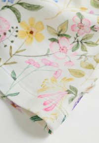 Lillemustriline kangas erinevates värvides, sealhulgas roosa, kollane ja roheline, pehme tekstuuri ja ümmarguste ääre detailidega.