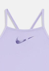 Lilla sporttop med tynde stropper, der har et struktureret, mørkeblåt Nike-logo foran. Glat stof og tætsiddende design.