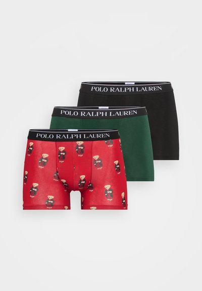 Three men's boxer briefs in red, green, and black; red features teddy bear pattern, all with black waistbands labeled "POLO RALPH LAUREN."