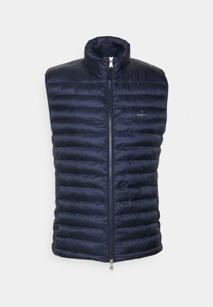 Marineblauwe doorgestikte mouwloze bodywarmer met rits aan de voorkant en hoge kraag, met klein GANT-logo op de linkerborst.