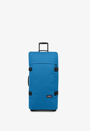 Maleta rodante de tejido azul brillante, de forma rectangular, con mango retráctil, asa lateral y acentos de plástico negro.