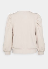 Bledě béžová mikina s texturovaným vzorem, která má balónové rukávy a ribbed pas a manžety. Zadní pohled zobrazuje kulatý výstřih.