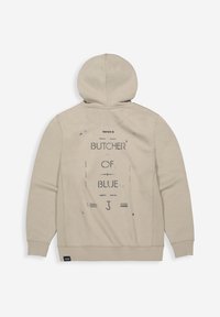 Beige hoodie met een grafische print "BUTCHER OF BLUE" op de achterkant. Zacht materiaal met een ontspannen pasvorm en geribde manchetten en zoom.