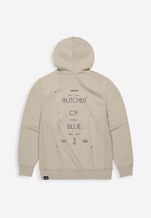 Beige hoodie met een grafische print "BUTCHER OF BLUE" op de achterkant. Zacht materiaal met een ontspannen pasvorm en geribde manchetten en zoom.