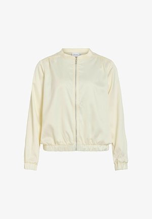 Veste légère de couleur crème avec manches longues, fermeture éclair à l'avant, poignets élastiques et taille élastique.