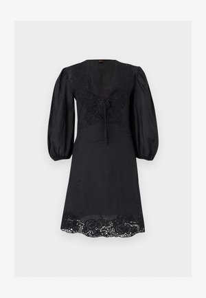 Zwarte knie-lange jurk met opgepofte driekwartmouwen, V-hals met strik, bloemenkant details op borst en zoom.