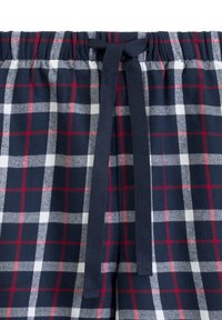 Granatowe spodnie w kratę z białym i czerwonym wzorem w kratkę, z elastycznym pasem i zawiązywaniem z materiału.