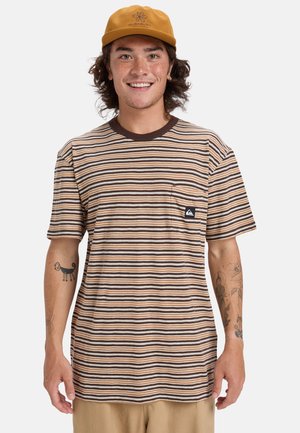 Striped short-sleeve t-shirt in brown, cream, and tan; features a pocket with a logo patch. Textured fabric. Worn with a tan cap.