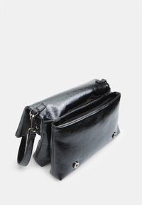 Black, textured faux leather bag with a fold-over flap, interior compartments, a detachable strap, and silver button accents.