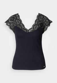 Débardeur noir à côtes avec un décolleté en V profond, agrémenté de détails en dentelle aux épaules et de bords festonnés. Accents de quincaillerie minimalistes à l'ourlet.