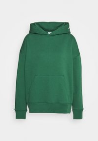 Felpa verde realizzata in morbido materiale, con tasca a marsupio, polsini a costine e vestibilità rilassata. Non presenta motivi né grafiche.