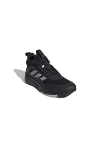 Baskets de sport noires avec un upper en maille, des accents texturés et trois rayures blanches. Équipées d'un col rembourré et d'une semelle en caoutchouc.