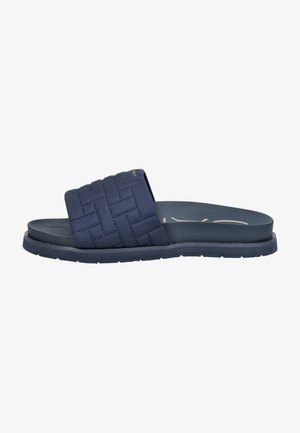 Navy blue slide sandal with woven fabric upper, flat rubber sole, and stitched detailing. Features a wide band for comfort and support.