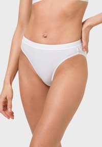 White cotton hipster briefs with a smooth texture, elastic waistband, and subtle branding along the top. Features a mid-rise cut.