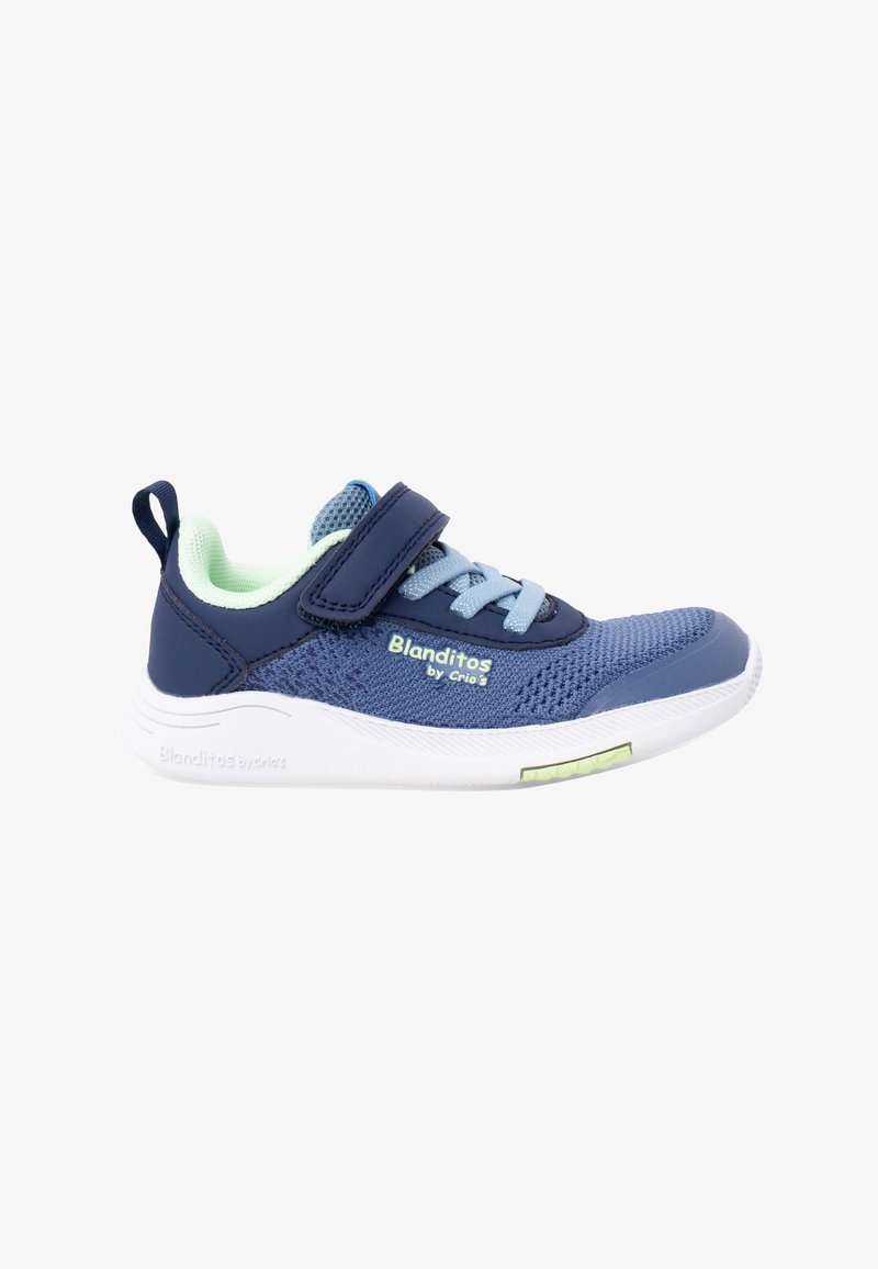 Baskets pour enfants bleu et marine avec doublure intérieure vert clair, bride en Velcro, lacets, semelle blanche et marque "Blanditos by Crio's" sur le côté.