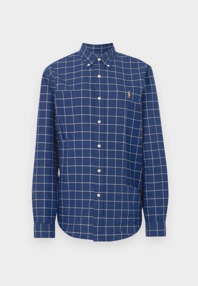 Modra srajca s karo vzorcem iz bombaža, z ovratnikom na gumbe, dolgimi rokavi in majhnim logotipom na prsih. Bel vzorec mreže.