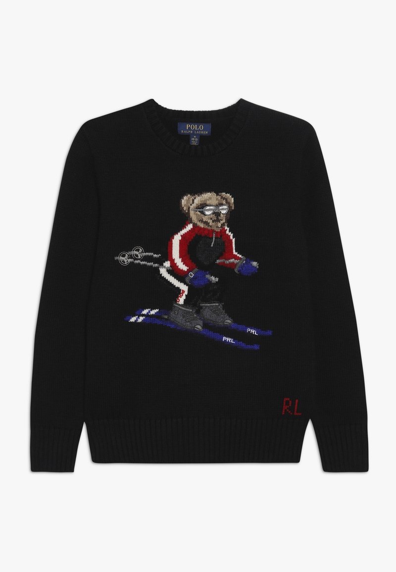 Svart stickad tröja med en skidande björnmotiv i röd och blå sportklädsel. Inkluderar broderade detaljer och ribbade ärmslut.