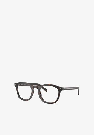 Lunettes optiques écaille avec une monture épaisse et rectangulaire et des accents transparents. Logo en métal sur la branche ajoutant un détail.