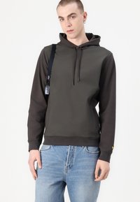 Hooded sweatshirt in dark green and black with a smooth texture, featuring a front kangaroo pocket and drawstring hood. Detailed with a logo on the sleeve.