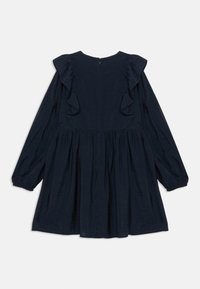 Námornícky modré šaty s dlhými vyp puffovanými rukávmi, volánovými detailmi na pleciach, textúrovanou tkaninou a uzatváraním na zips na zadnej strane. Rozšírený strih.