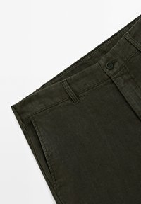 Dark green linen trousers with a flat front, button closure, and belt loops. Features subtle texture and a streamlined design.