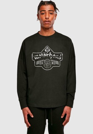 Black long-sleeve t-shirt featuring a silver Motörhead graphic logo. Made of cotton, it has a relaxed fit and ribbed neckline.