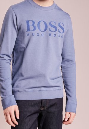 Blue crewneck sweatshirt made of soft fabric, featuring a large graphic "BOSS" print and ribbed cuffs and hem for a fitted look.
