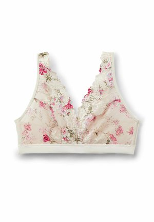 Měkká béžová krajková braletka s růžovým a zeleným květinovým vzorem, vroubkovanými okraji a hlubokým výstřihem do V, zobrazena na bílém pozadí.