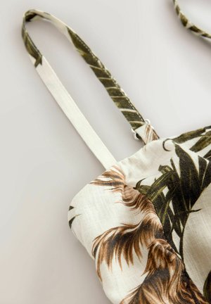 Torba z materiału w kwiatowy wzór z zielonymi i brązowymi liśćmi. Posiada cienkie paski i jasno beżowe tło o miękkiej teksturze.