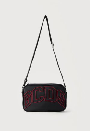 Black rectangular crossbody bag with adjustable strap and large red outlined letters "GCDS" on the front.