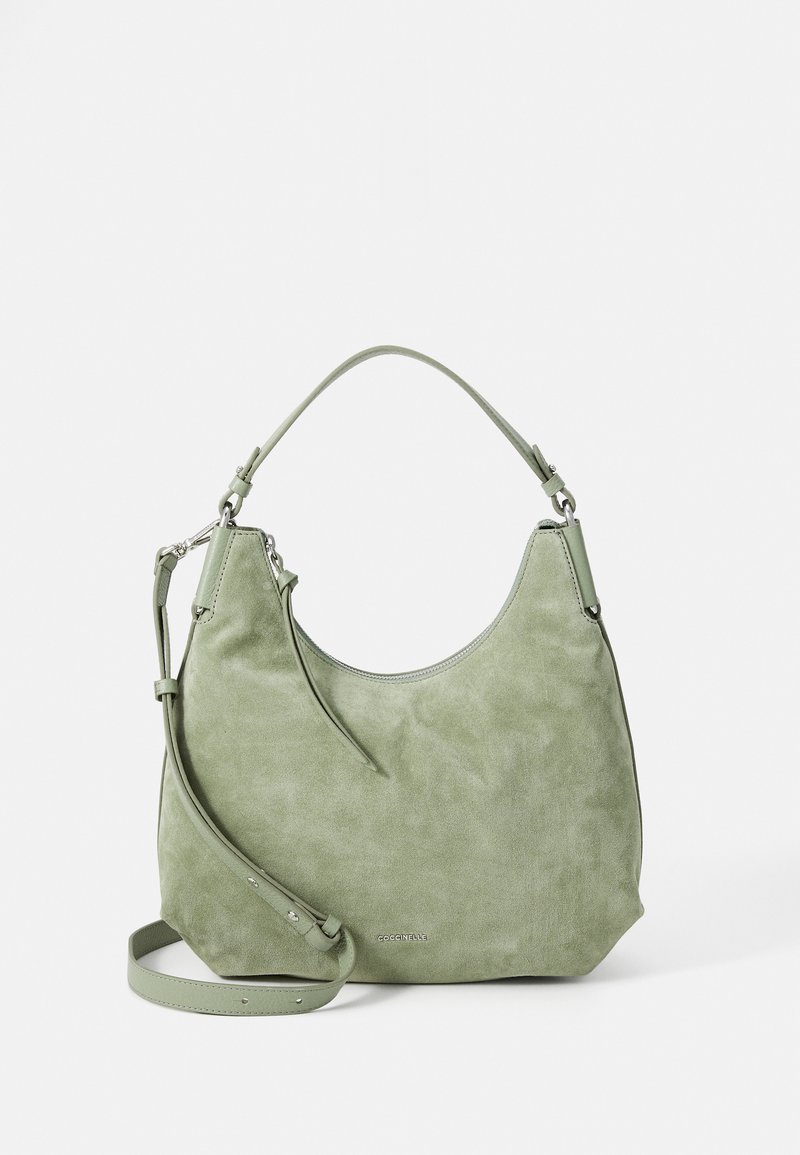 Green suede handbag with a curved shape, single top handle, and detachable shoulder strap. Features a silver-tone logo detail on the front.