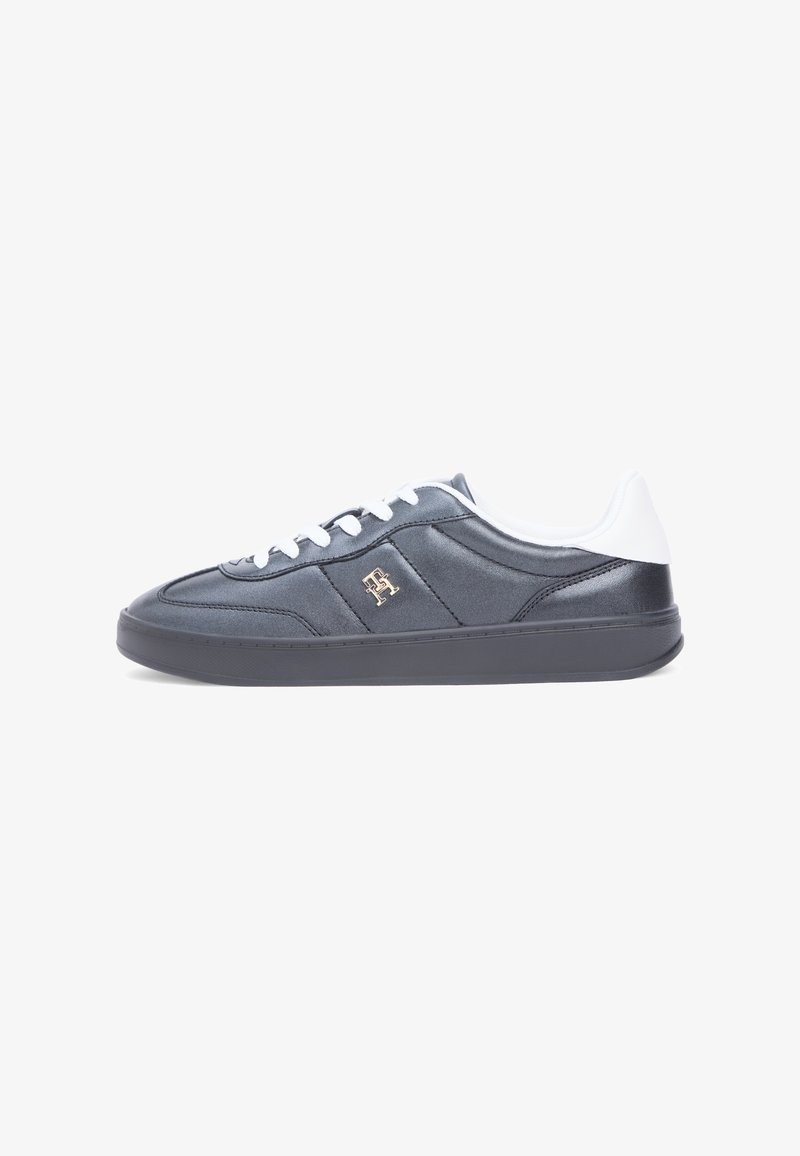 Sneakers in dark gray satin material with white accents, flat rubber sole, round toe, and lace closure. Features a small gold logo on the side.