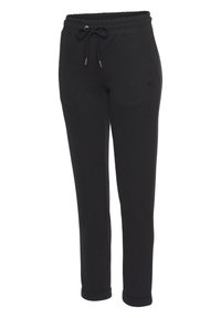 Schwarze Sweatpants aus Baumwollmischung, mit elastischem Taillenbund und Zugband, seitlichen Taschen und schmalem Schnitt.
