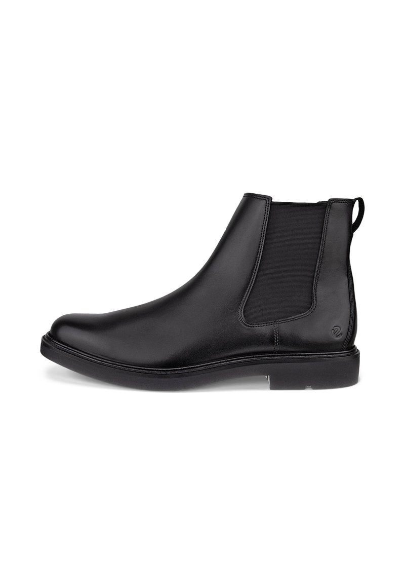 Bottine Chelsea en cuir noir avec panneaux latéraux élastiques et petit talon, conçue pour un enfilage facile.