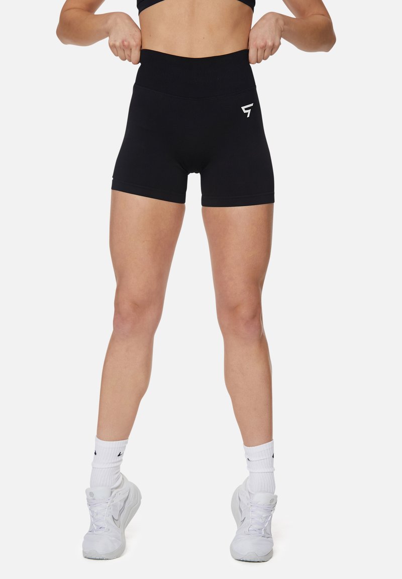 Pantaloni sportivi neri a vita alta realizzati in tessuto elastico, con una texture liscia e un logo sulla coscia sinistra.