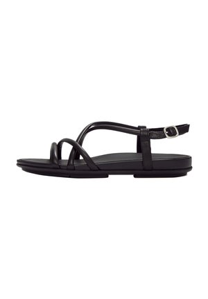 Black flat sandal with thin leather straps crossing over the toes and an adjustable ankle strap with a silver buckle.