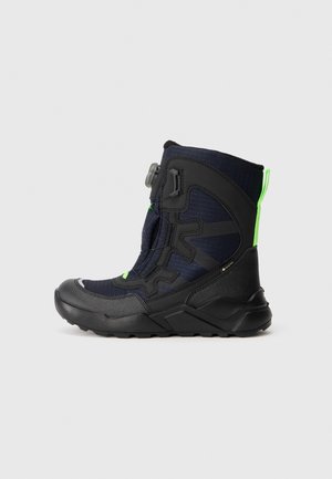 Navy and black waterproof boot with a textured upper, a rubber sole, and a bright green accent. Features a side adjustment closure and sturdy design.