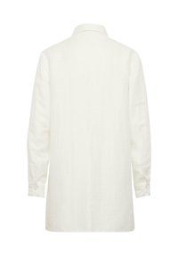 White linen long-sleeve shirt with a collar and buttoned cuffs. Soft texture, straight cut, and a back pleat for ease of movement.