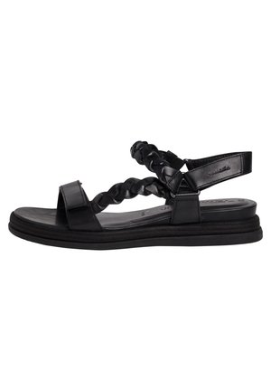 Black sandals with a flat sole, featuring braided straps and adjustable ankle support. Made of smooth material with minimalistic design.